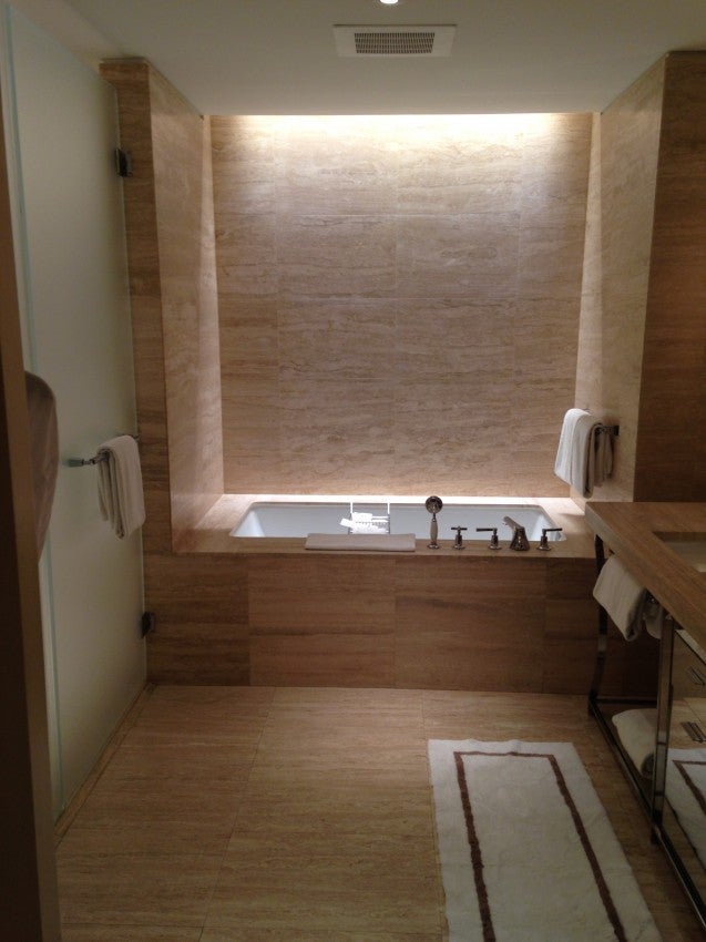 The luxurious bathroom, including a deep, recessed tub at the far end.