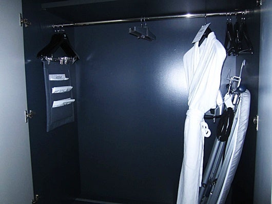 The ironing board inside the closet