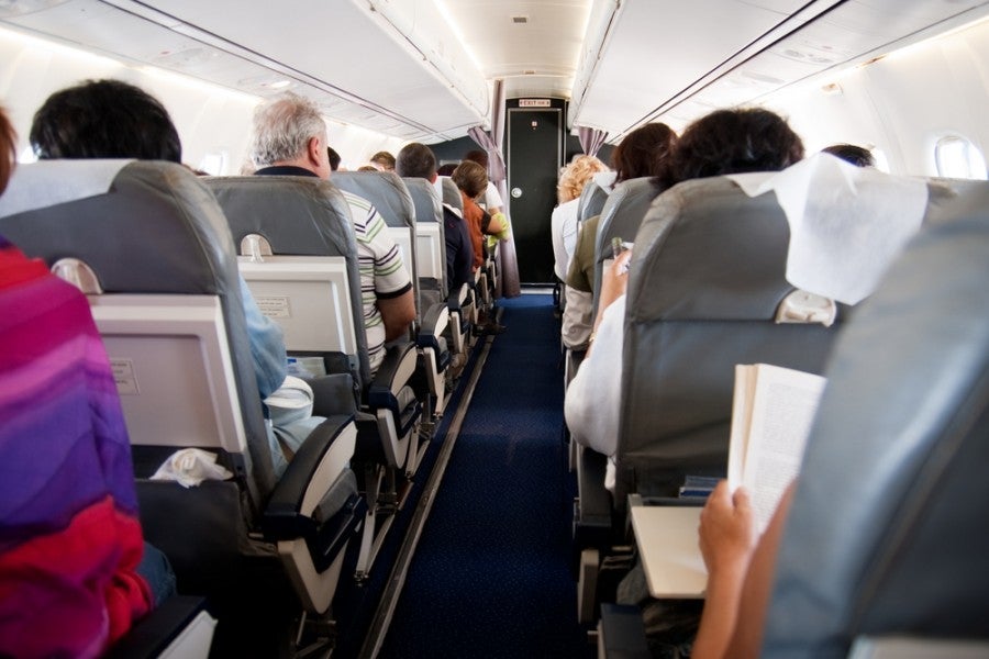 Getting stuck in a middle seat on a long flight is not fun. Photo courtesy of Shutterstock.