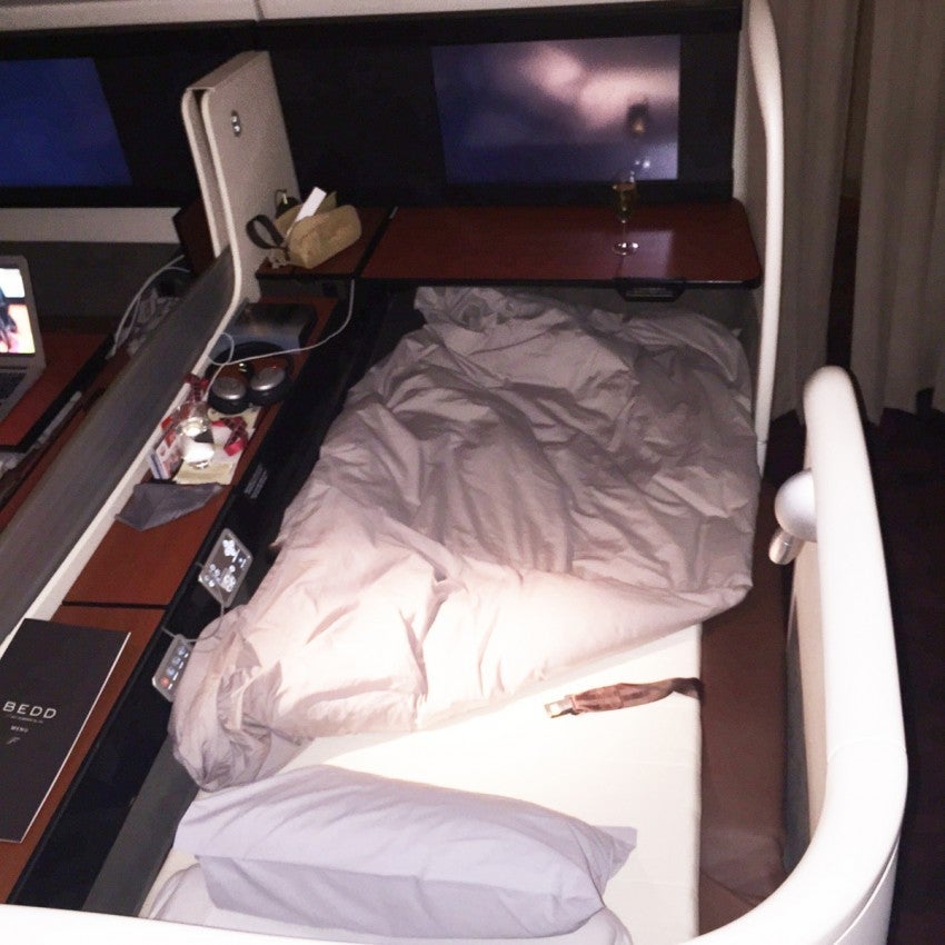 The mattress pad, pillow and blanket that turned my Sky Suite's lie-flat seat into a bed.