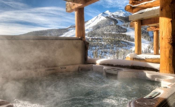 Enjoy a winter jacuzzi in a mountain-side Montana cabin found on VRBO.