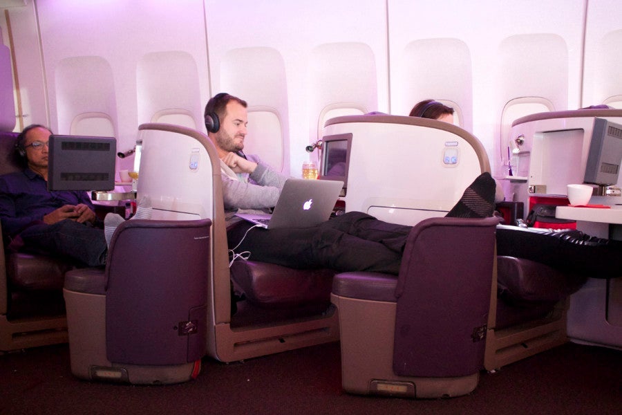 Passengers enjoying various personal entertainment.