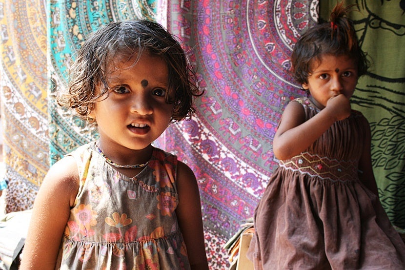 Shopping in India is fun, and these two little girls helped me choose some great gifts at a street market. Photo by Lori Zaino.