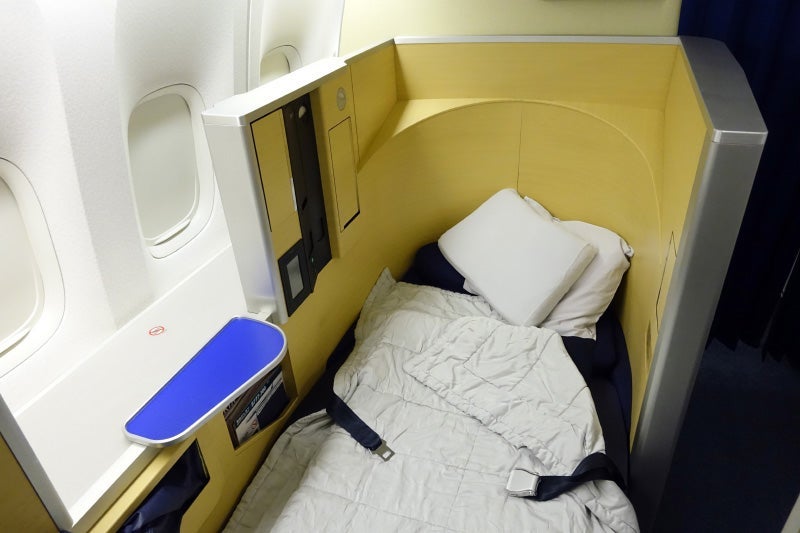 The flight attendant converted the empty seat next to mine into a bed.