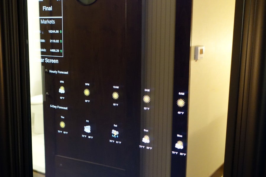 This smart mirror, installed in an Element demo room, displays weather, stock info and news.