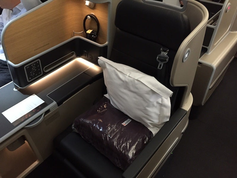 A side seat with the narrow armrest on the aisle.