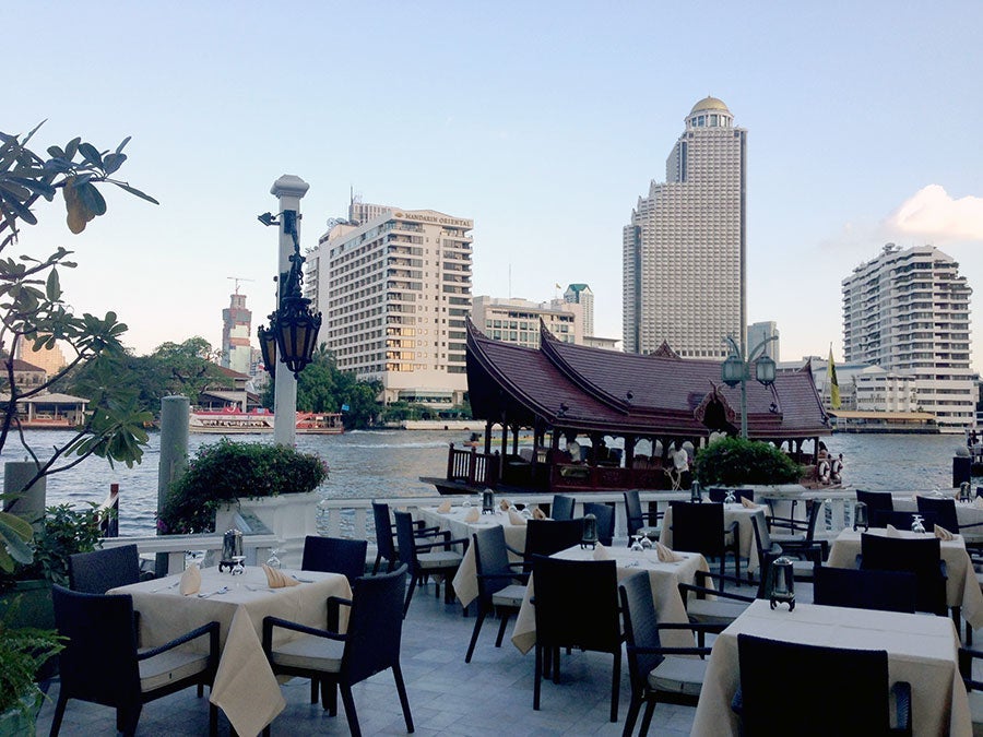 Al fresco dining by the river in Bangkok.