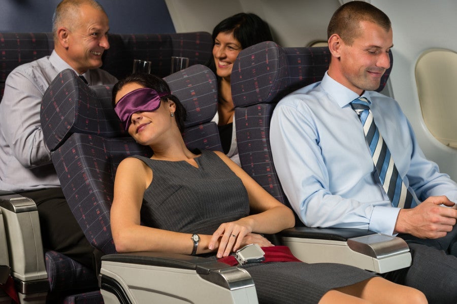 Which one of these four travelers will be the least jet lagged when landing in Europe? You got it, the one that's asleep! Photo courtesy of Shutterstock.