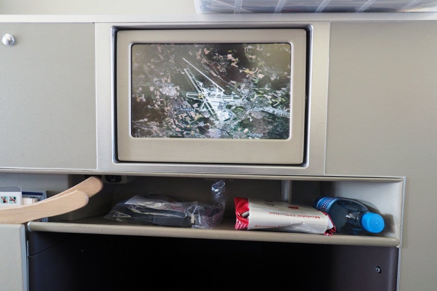 This shelf beneath the IFE screen is the only storage available at each seat.