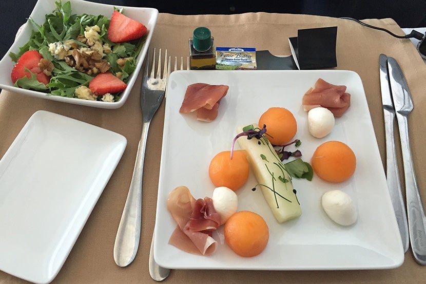 Plane food? My mozzarella, prosciutto and cantaloupe appetizer sure beats out the salad in economy.