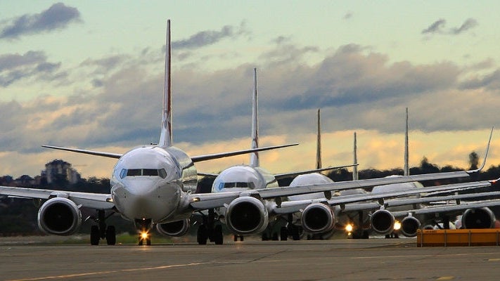 airplanes in line on runway full shutterstock 198700100