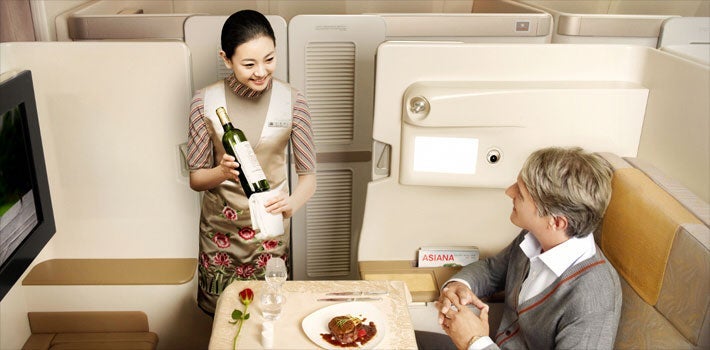 Asiana's first-class suites aren't flashy, but they feature privacy doors and fully flat beds.