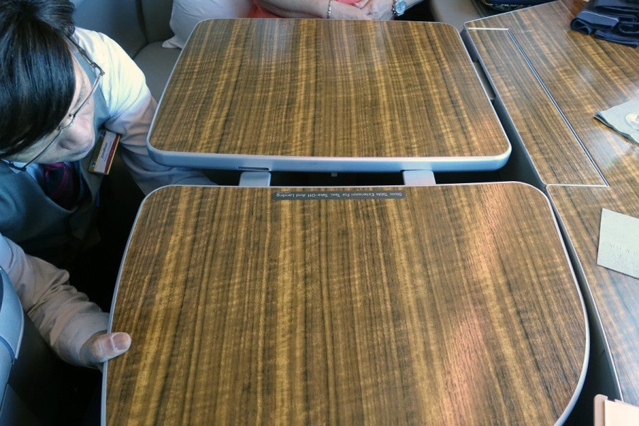 Flight attendants can install a table extender so you can dine with a companion.