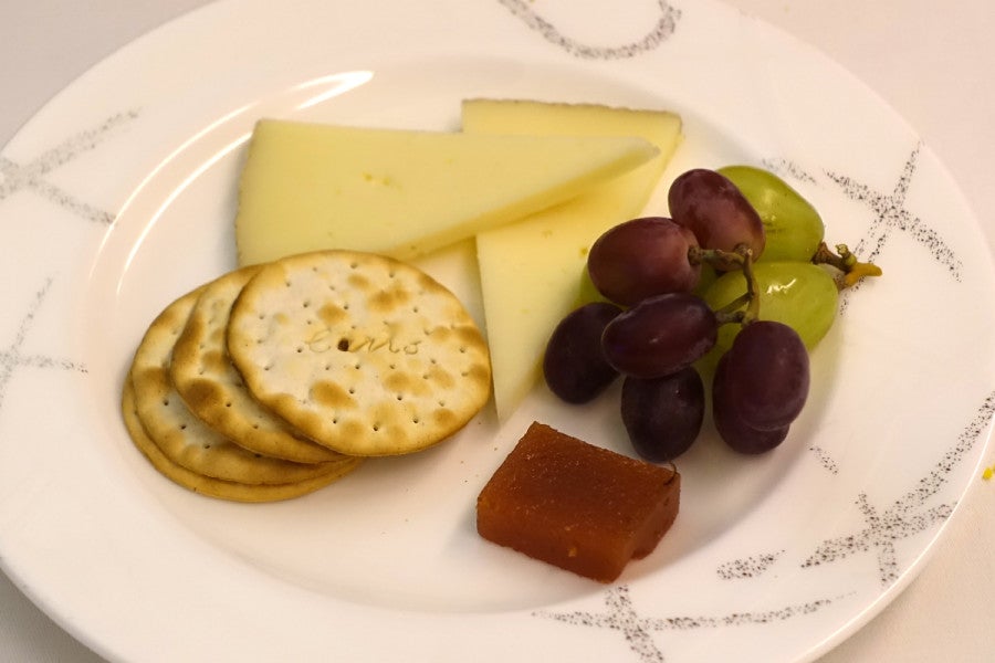 Cheese was served with grapes and a sweet jam.