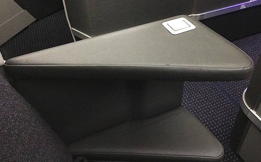 The armrests on the front-facing seats go down, while those on the rear-facing seats do not.