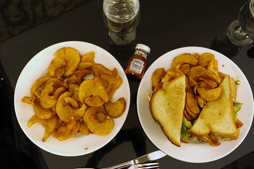 A club sandwich and plentiful French fries — a perfect late-night room-service dinner.