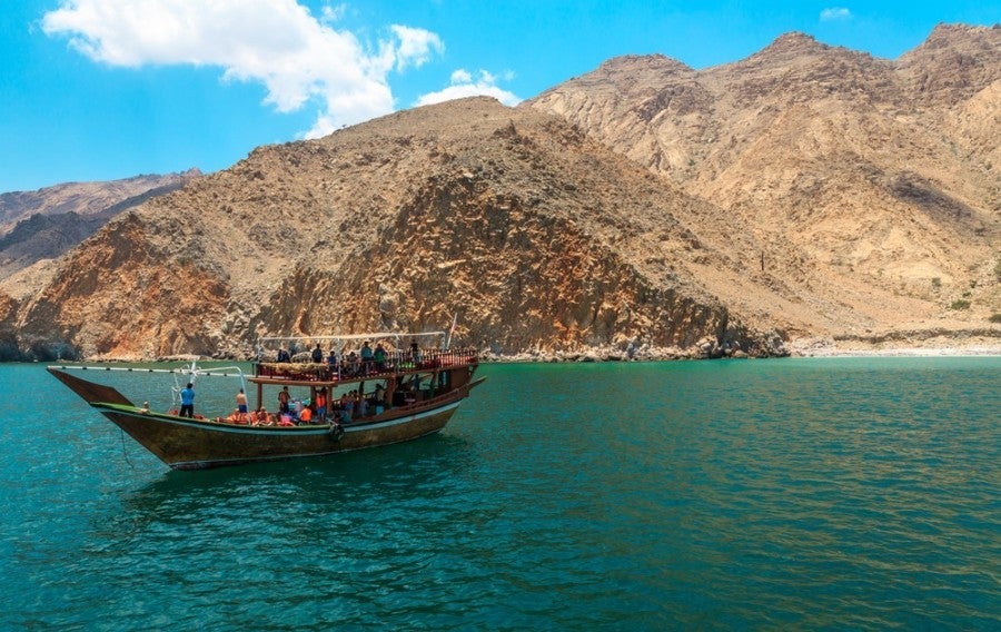 Take a dhow cruise through the jaw-dropping desert fjords of Oman. Photo courtesy of Shutterstock.