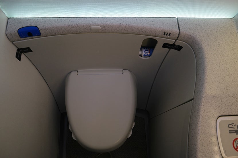 Tabbed toilet seat so you don't have to touch the rim: Brilliant! Image courtesy of Kofi Lee-Berman.