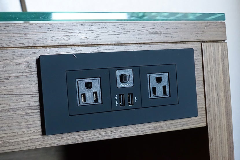 One perk of a cookie-cutter hotel: conveniently located bedside outlets.