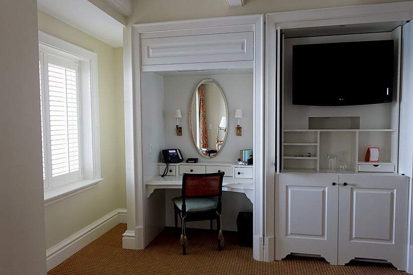 The desk was small and oddly positioned directly under an air vent.