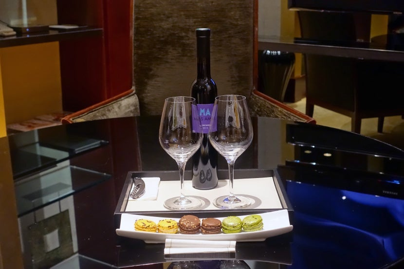 A welcome gift of red wine and macarons.