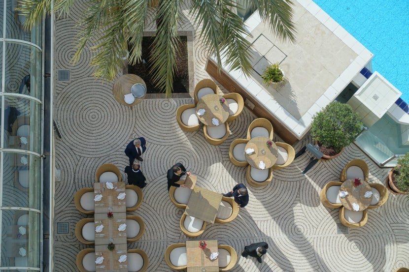 Staff preparing tables at Le Relais restaurant.