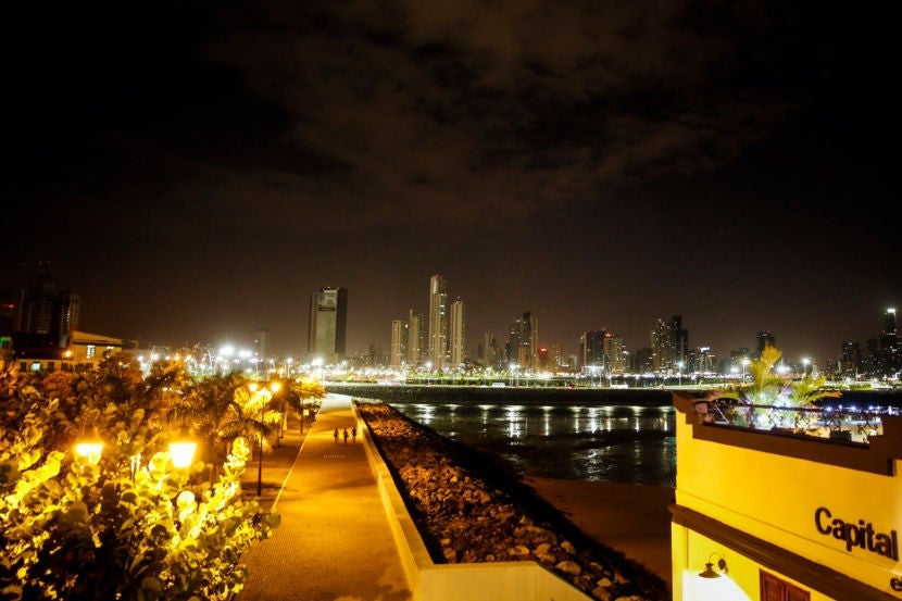 The city glows from the rooftop of Capital Bistro at night.