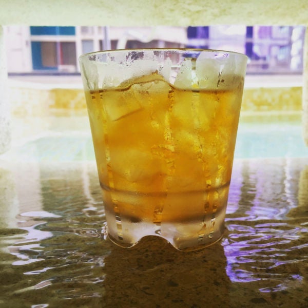 A glass of Ron Abuelo poolside at the Waldof Astoria Hotel.