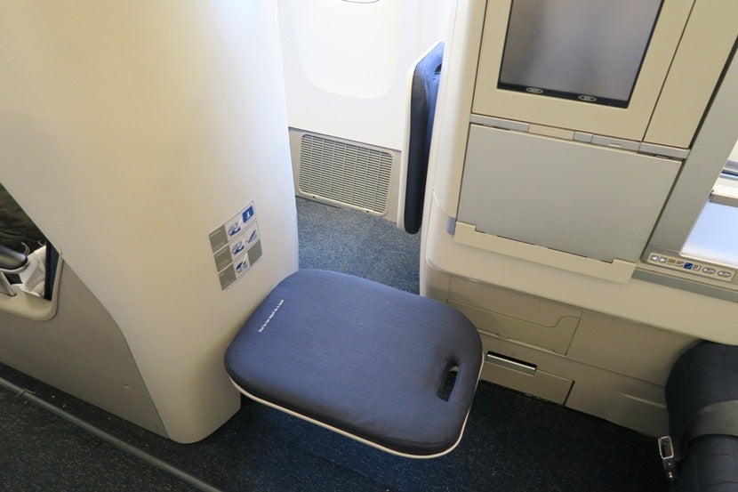 The narrow opening to reach the window seats is made harder if your cabinmate has their footrest down.