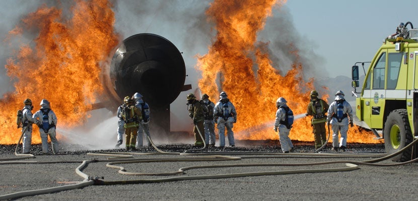 Here, firefighters practice what to do in case of an aircraft fire. Image courtesy of Shutterstock.