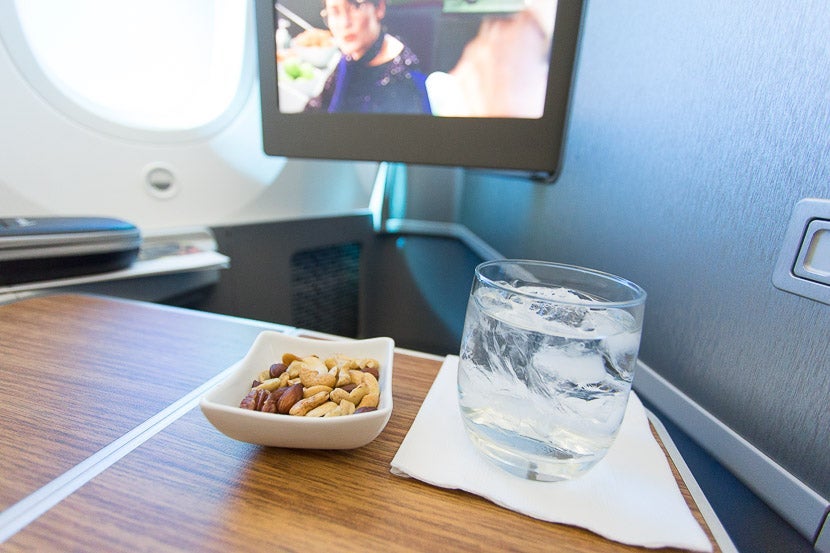 Hot towels, nuts and a drink are distributed shortly after takeoff.