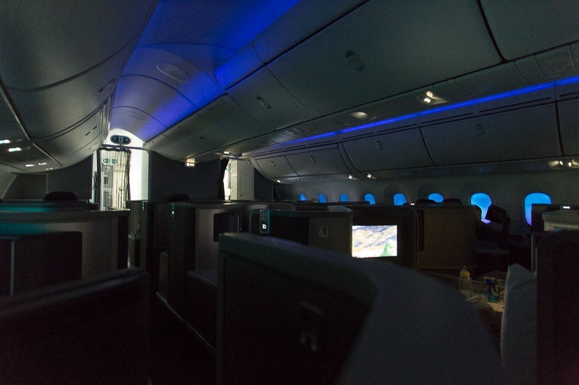 With all of the windows dimmed, there's still a blueish glow throughout the cabin during a daytime flight.