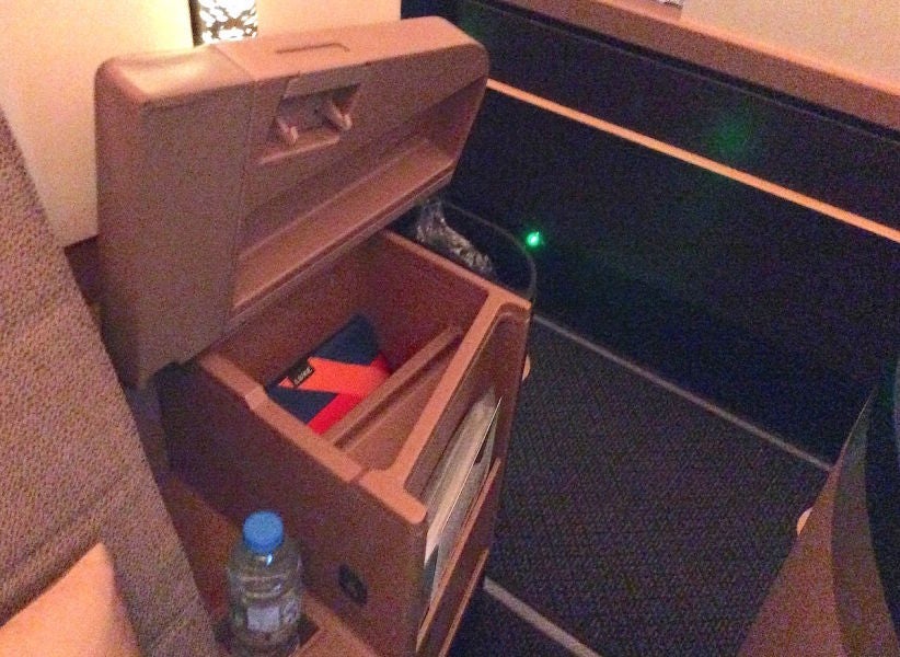 The storage cubby inside the wide armrest.