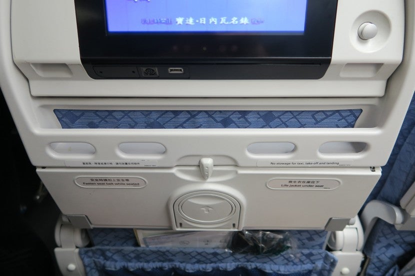 The tray below the IFE screen is very useful for storing your cell phone and boarding pass.