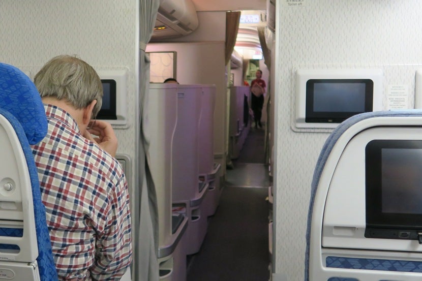 With everyone seated and ready for takeoff, the cabin crew passed the time by collecting funds for UNICEF.