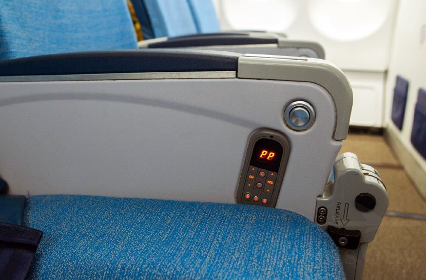 A small entertainment control is fixed to the seat.