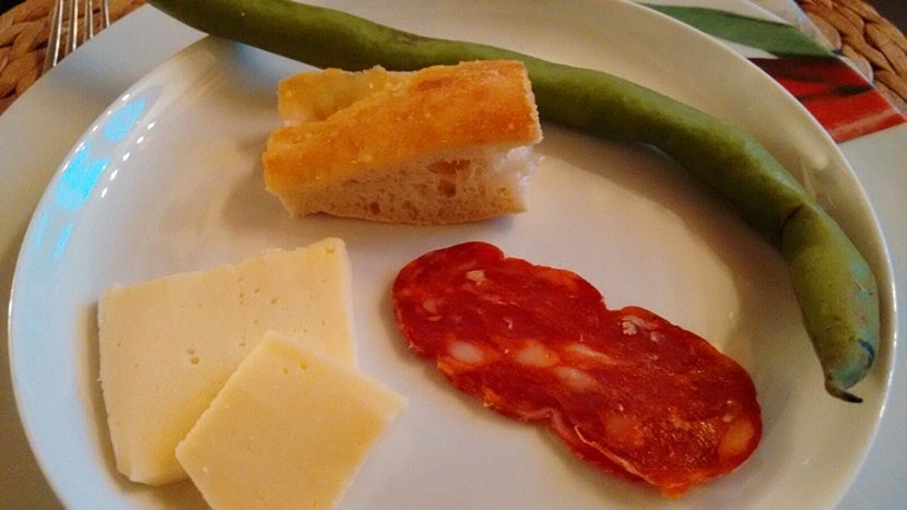 A fava bean paired with pecorino cheese, a slice of sausage and some bread. Photo by Donna Pucciani.