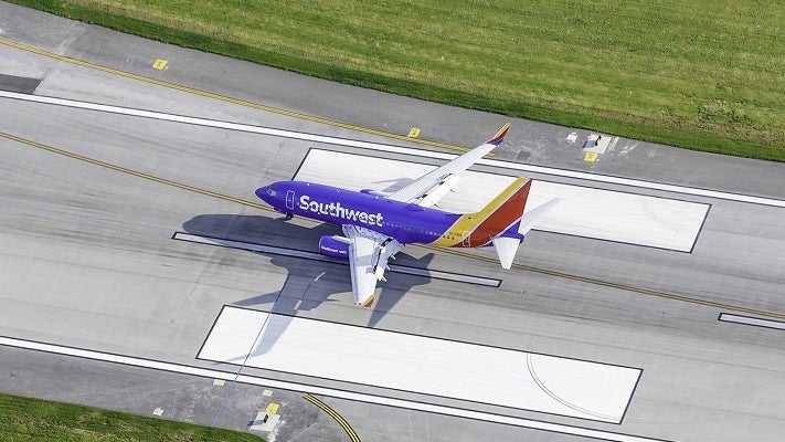 Southwest plane taxiing on runway Chicago Midway large featured shutterstock 318608912