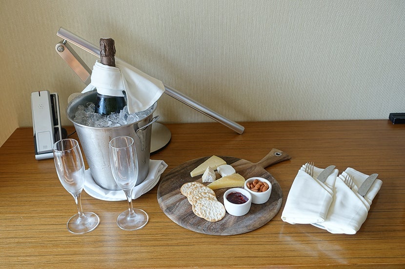 A welcome gift of sparkling wine plus cheese and crackers.