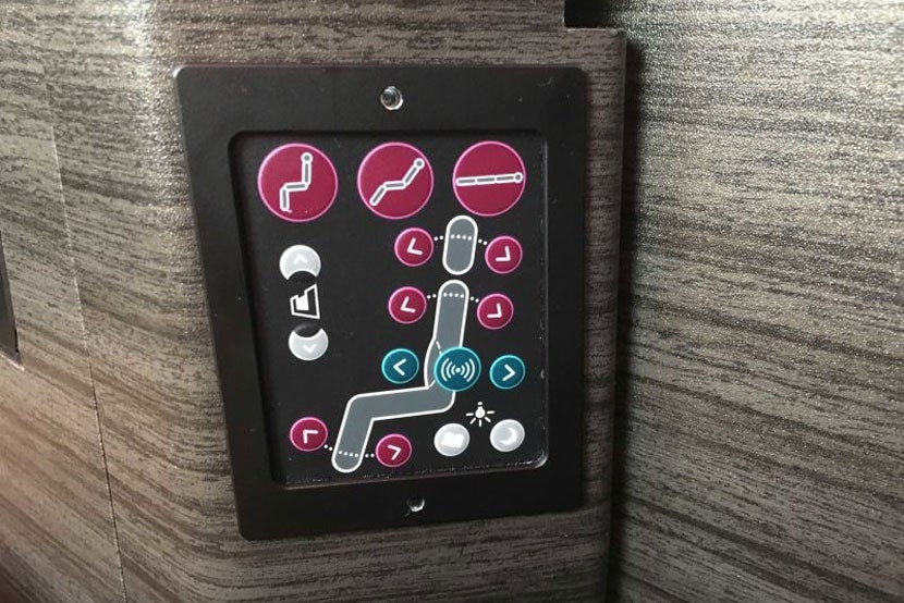The business class seat controls.