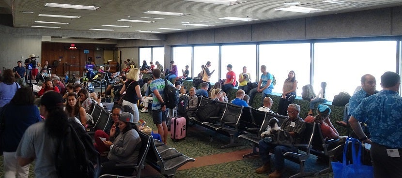 Passengers wait for the next flight.