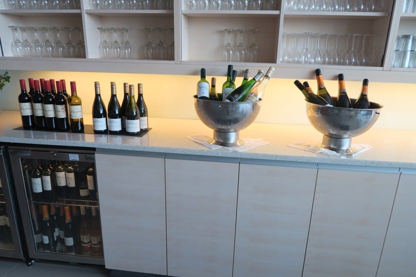 In order to keep up with the busy lounge, the lounge left out many bottles of each type of wine and champagne.