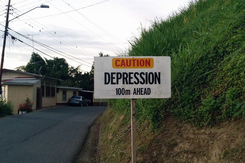 Driving the mountains of Tobago put me in a good mood, despite the warning sign. Image courtesy of the author.