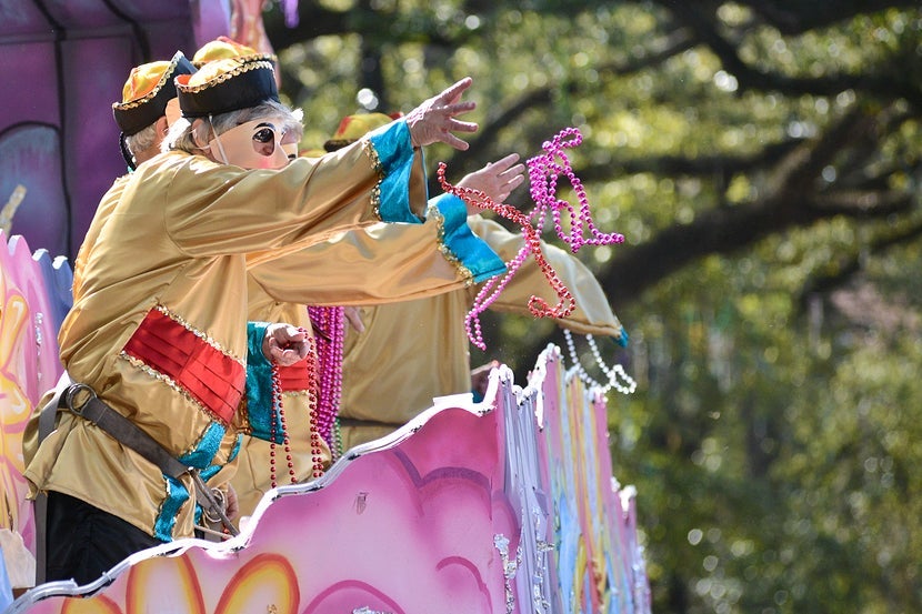 Catching "throws" during parades is a must-do activity for both adults and kids during Mardi Gras. Image courtesy of Shutterstock.