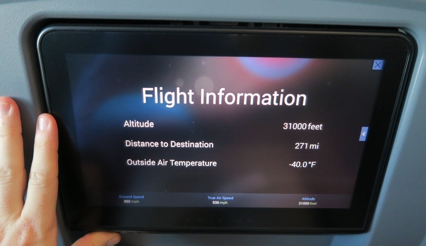 In-flight entertainment screen with my hand as a comparison.