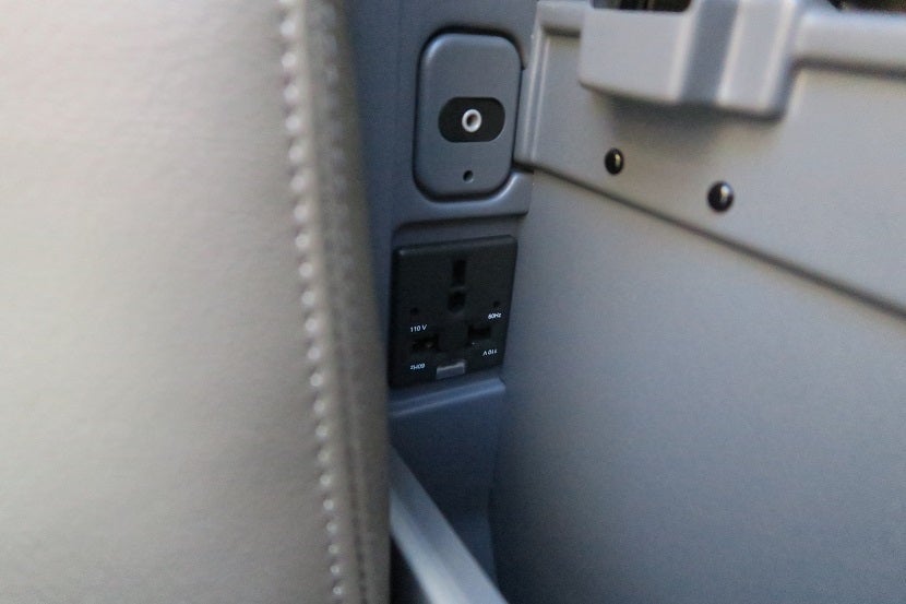 There's a headphone jack and AC power plug in the between-seat storage well.