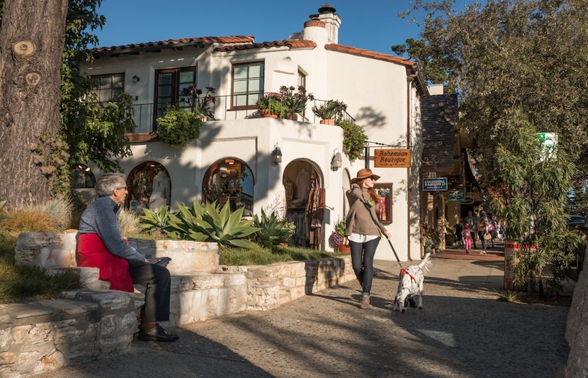 City-dwellers love to escape to the picturesque town of Carmel. Image courtesy of <a href="http://www.shutterstock.com/pic-344715023/stock-photo-carmel-by-the-sea-california-united-states-november-28-2015-a-fashionably-dressed-tall-and-slender-woman-strolls-down-a-sidewalk-in-carmel-on-a-november-afternoon.html?src=ulZXq4TrSkZiZufelE3Gnw-1-1">Shutterstock</a>.