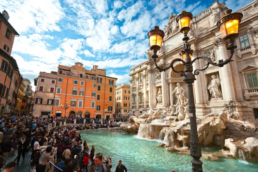 All these tourists tossing coins into the fountain are actually supporting a charitable cause. Image courtesy of <a href="http://www.shutterstock.com/dl2_lim.mhtml?src=KkP95SPN0JYs9shkZqixbg-1-24&id=127897592&size=medium_jpg">Shutterstock</a>.