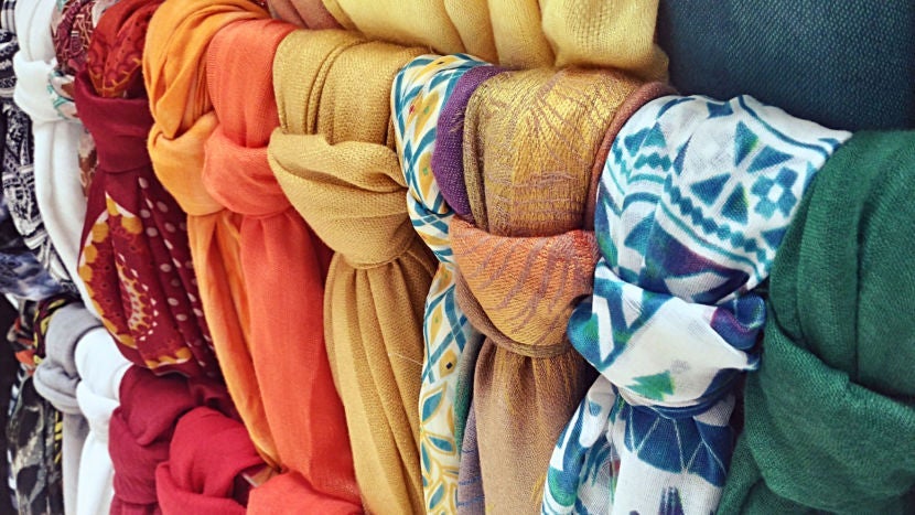 You can't go wrong with a colorful scarf-cum-beach blanket-cum-best friend. Image courtesy of Ethan Jorge Fazon / EyeEm via Getty Images.