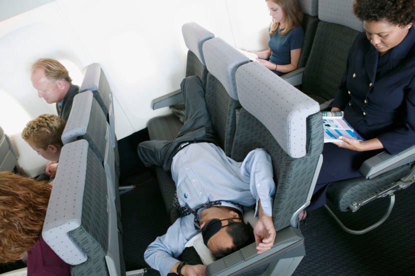 All you need to sleep soundly on the plane are an eye mask and some good earplugs. Image courtesy of ColorBlind Images via Getty.